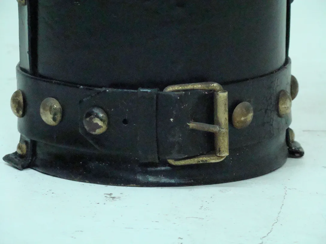 Old umbrella stand with black and metal details