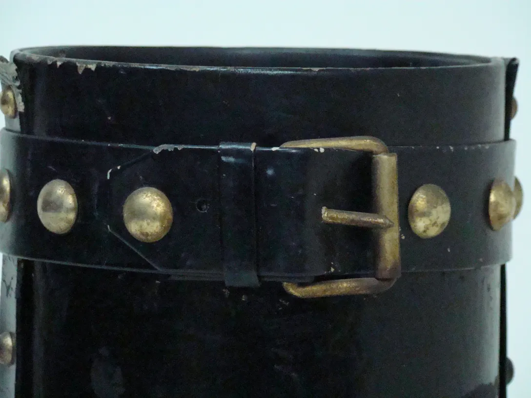 antique umbrella stand with gold details at the top