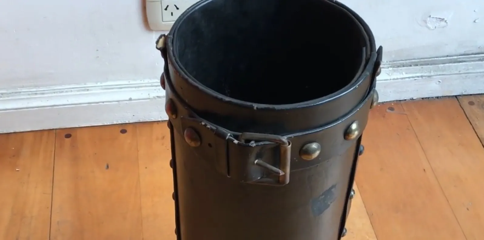 antique cylindrical umbrella stand with decorative elements