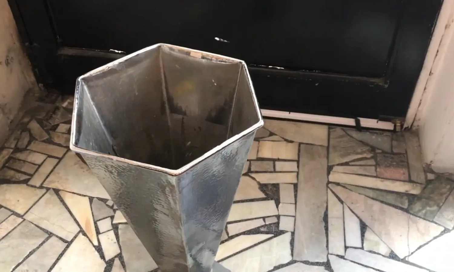 antique hexagonal umbrella stand in a cozy setting