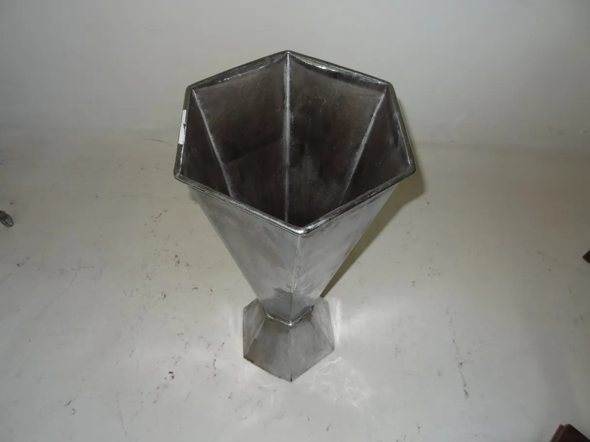 Antique umbrella stand with hexagonal shape in the setting