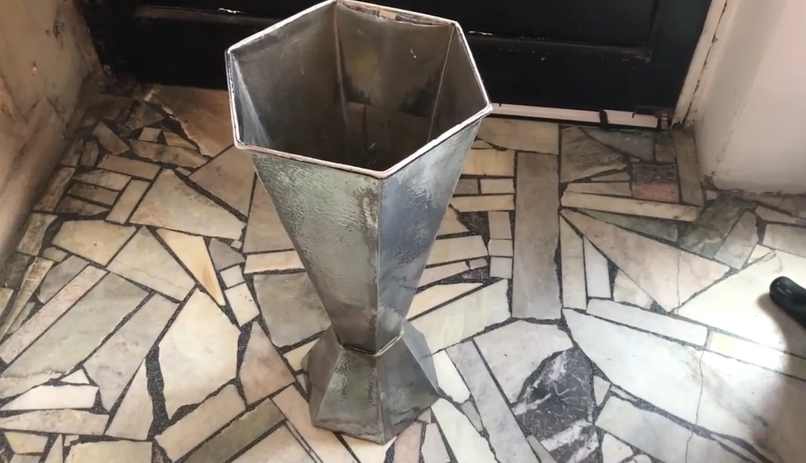Antique hexagonal umbrella stand with sturdy base and elegant design.