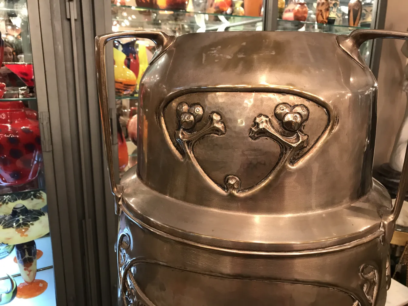 antique kayser umbrella stand with a shiny finish and relief details