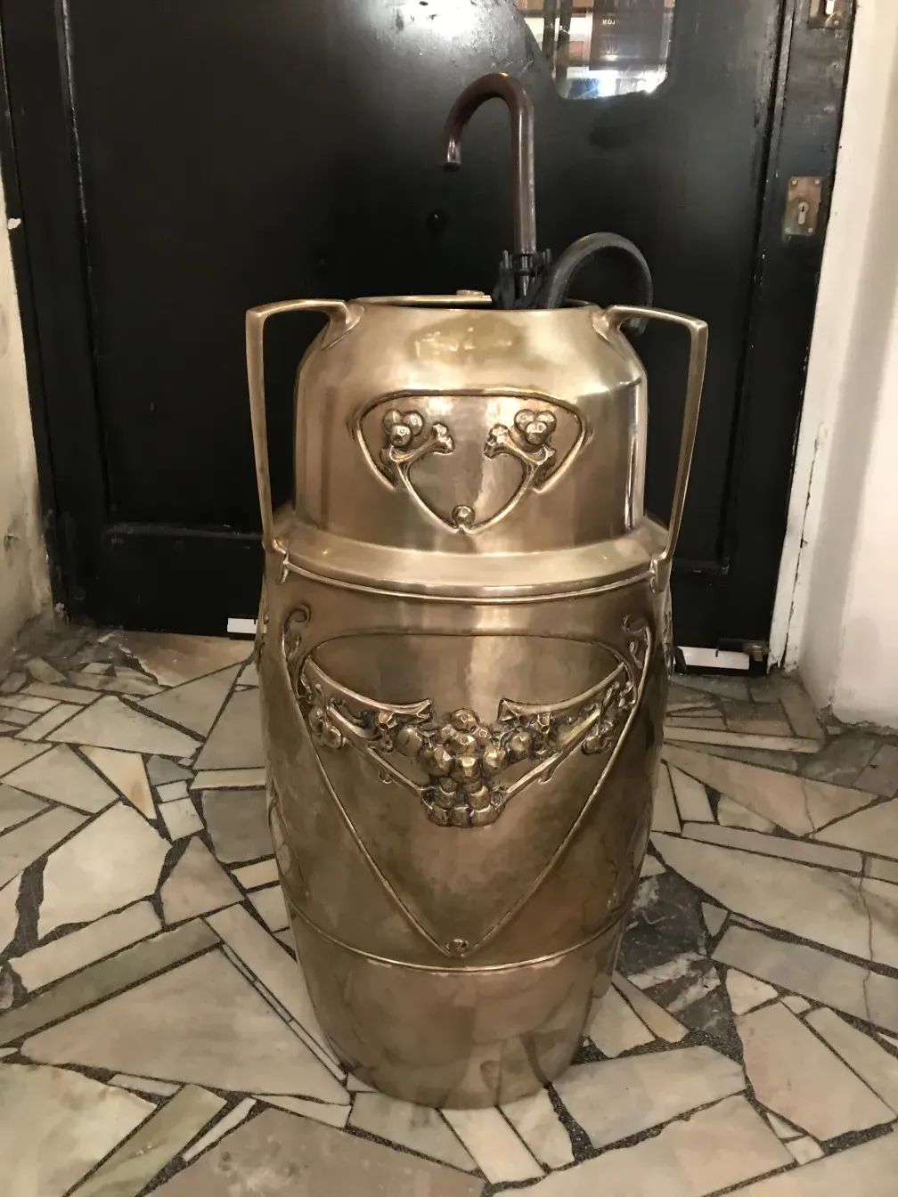 antique umbrella stand with decorative metal details