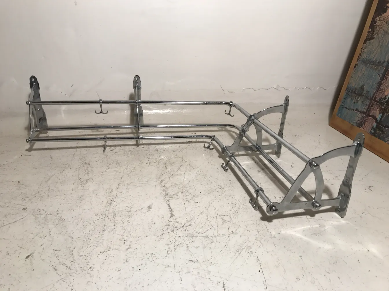 Antique coat rack with multiple hooks in a neutral setting