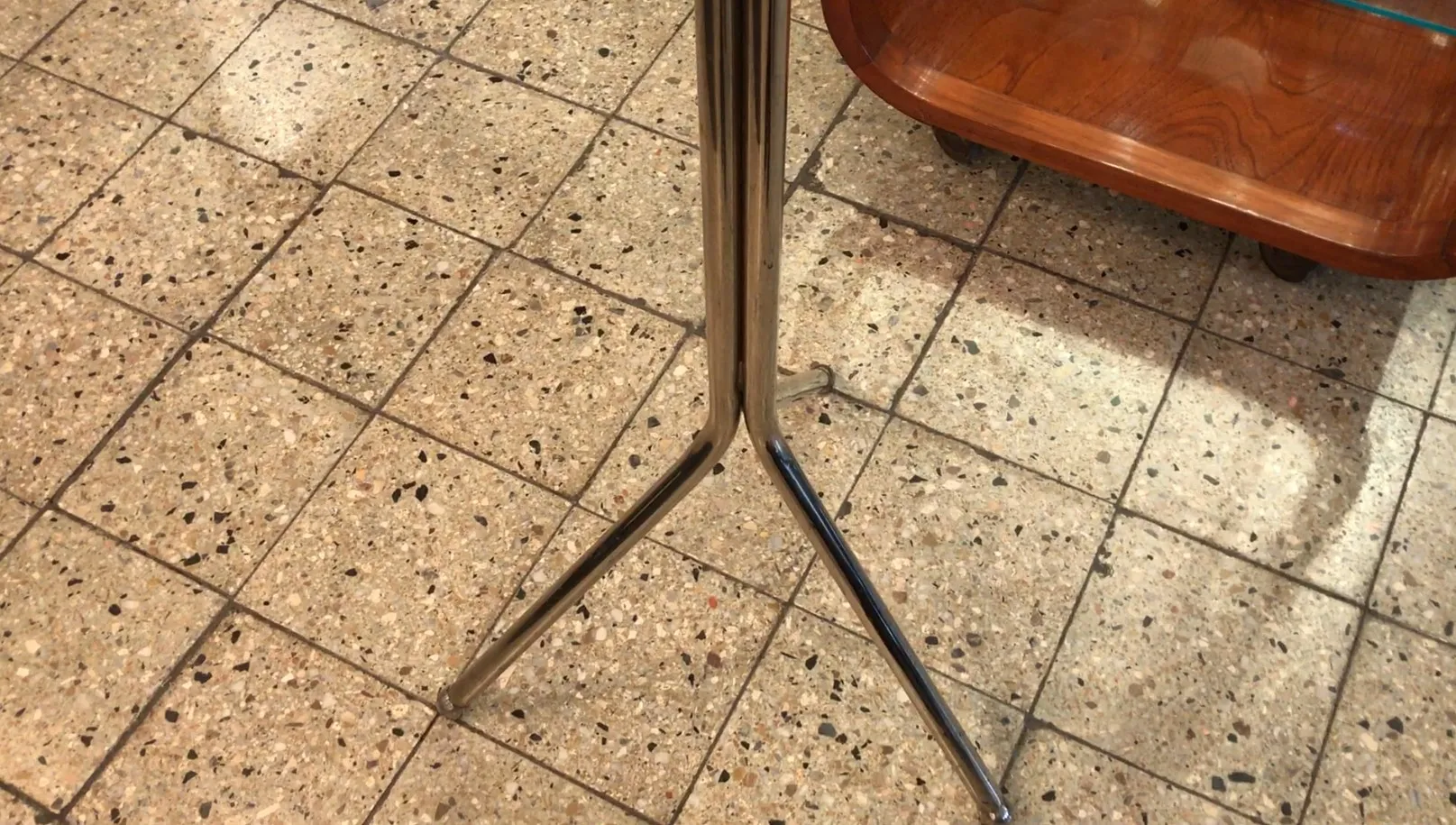 antique coat rack with a triangular base in a cozy environment