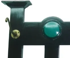 antique black coat rack with gold hook and green detail