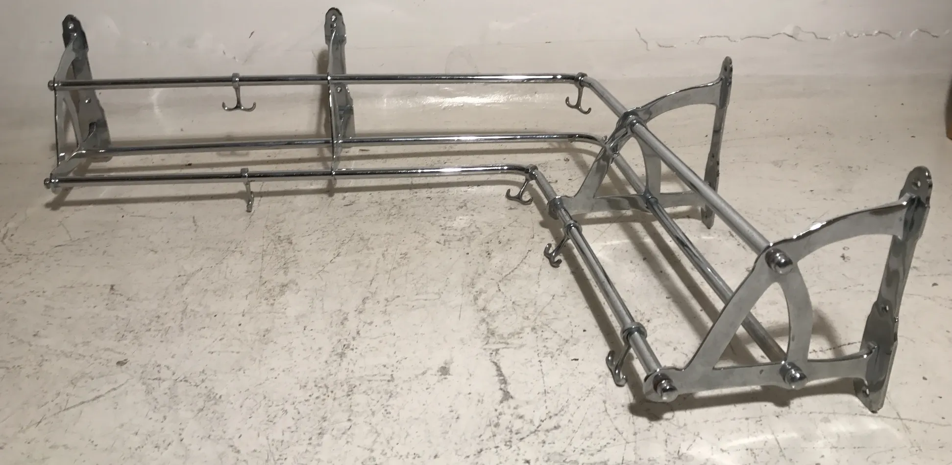 antique coat rack on a light background with multiple hooks