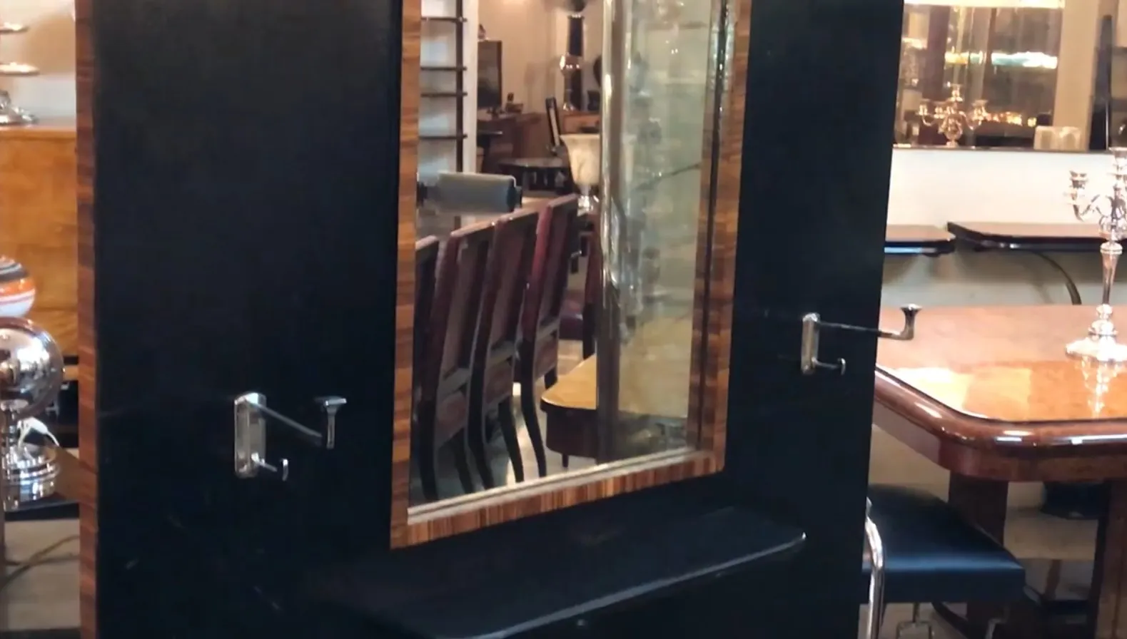 antique coat rack with a decorative mirror, dark background