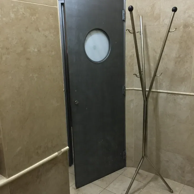 antique coat rack with hooks in a bathroom