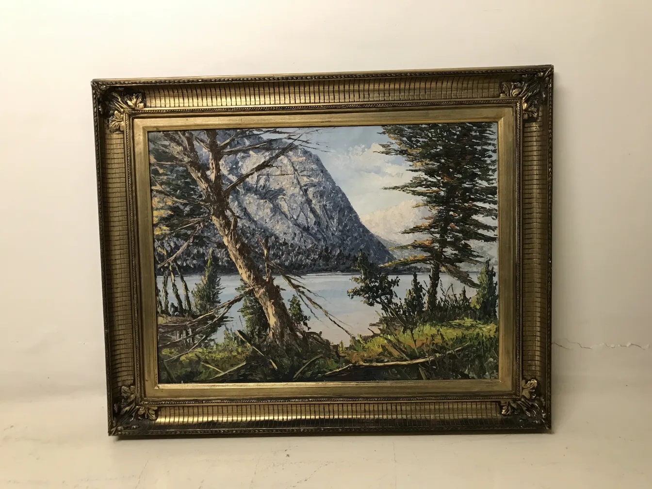 antique painting depicting a natural landscape with ornate frame