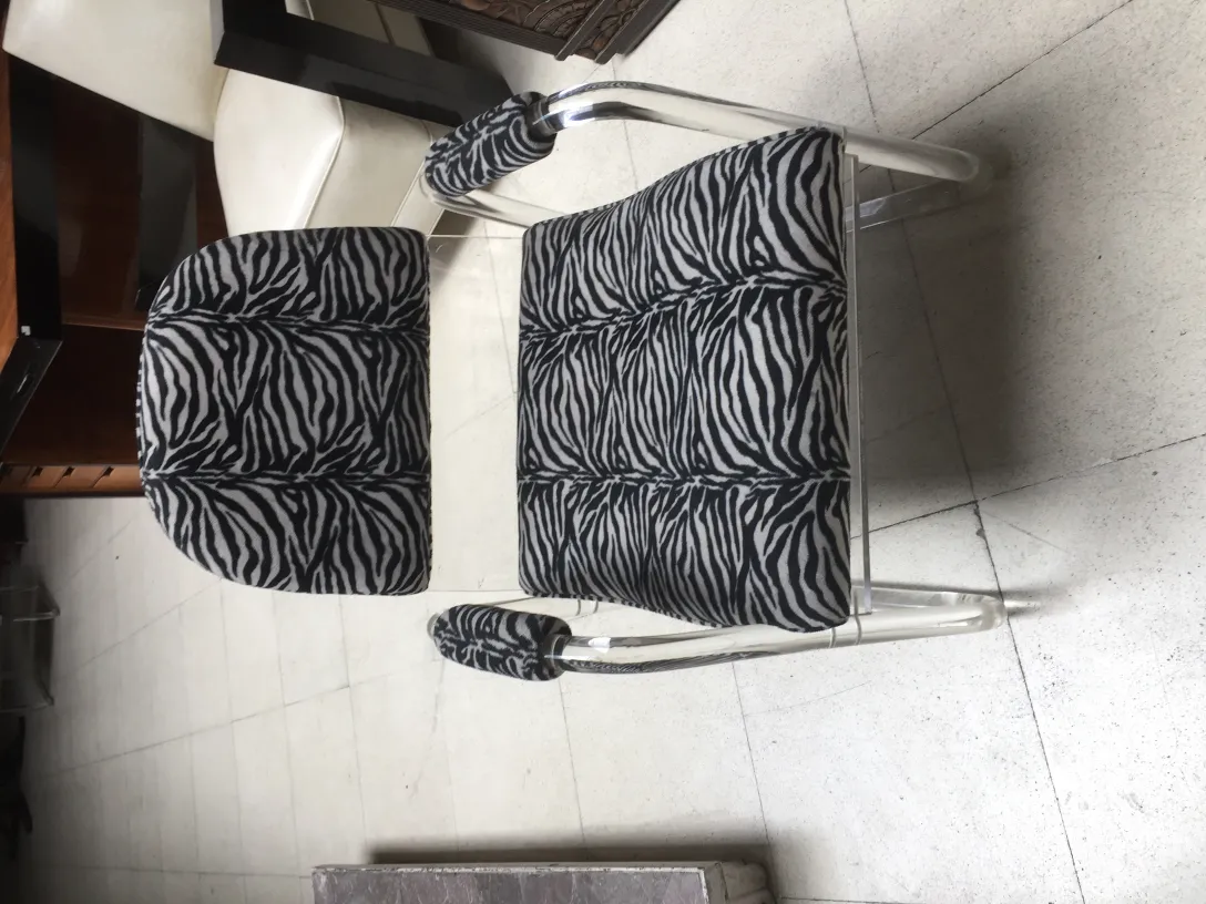 2 armchairs featuring zebra design in an antique setting