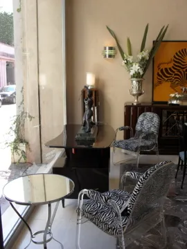 Two antique armchairs with an elegant design in a cozy setting.