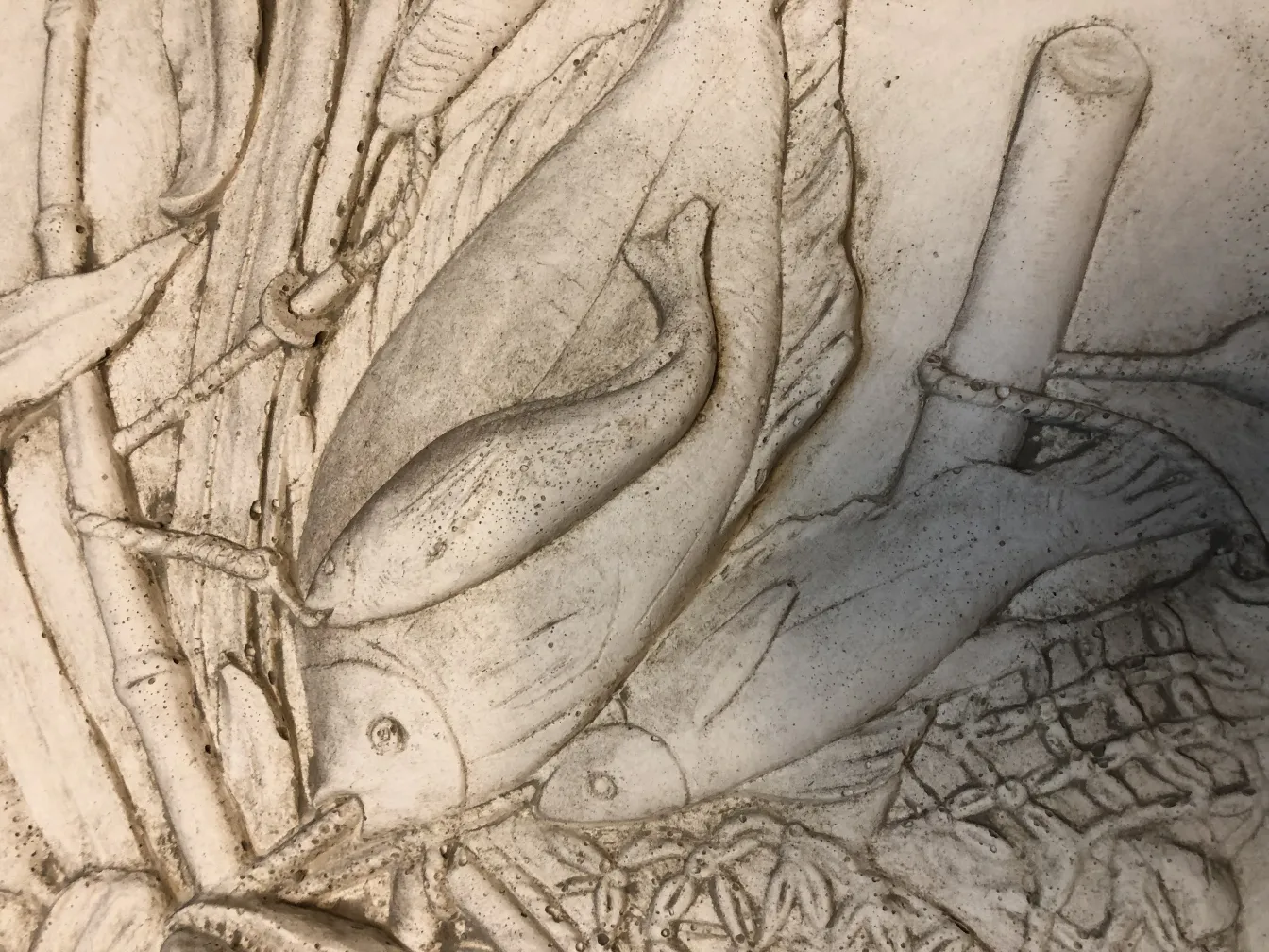 Antique wall plate featuring fish and natural elements