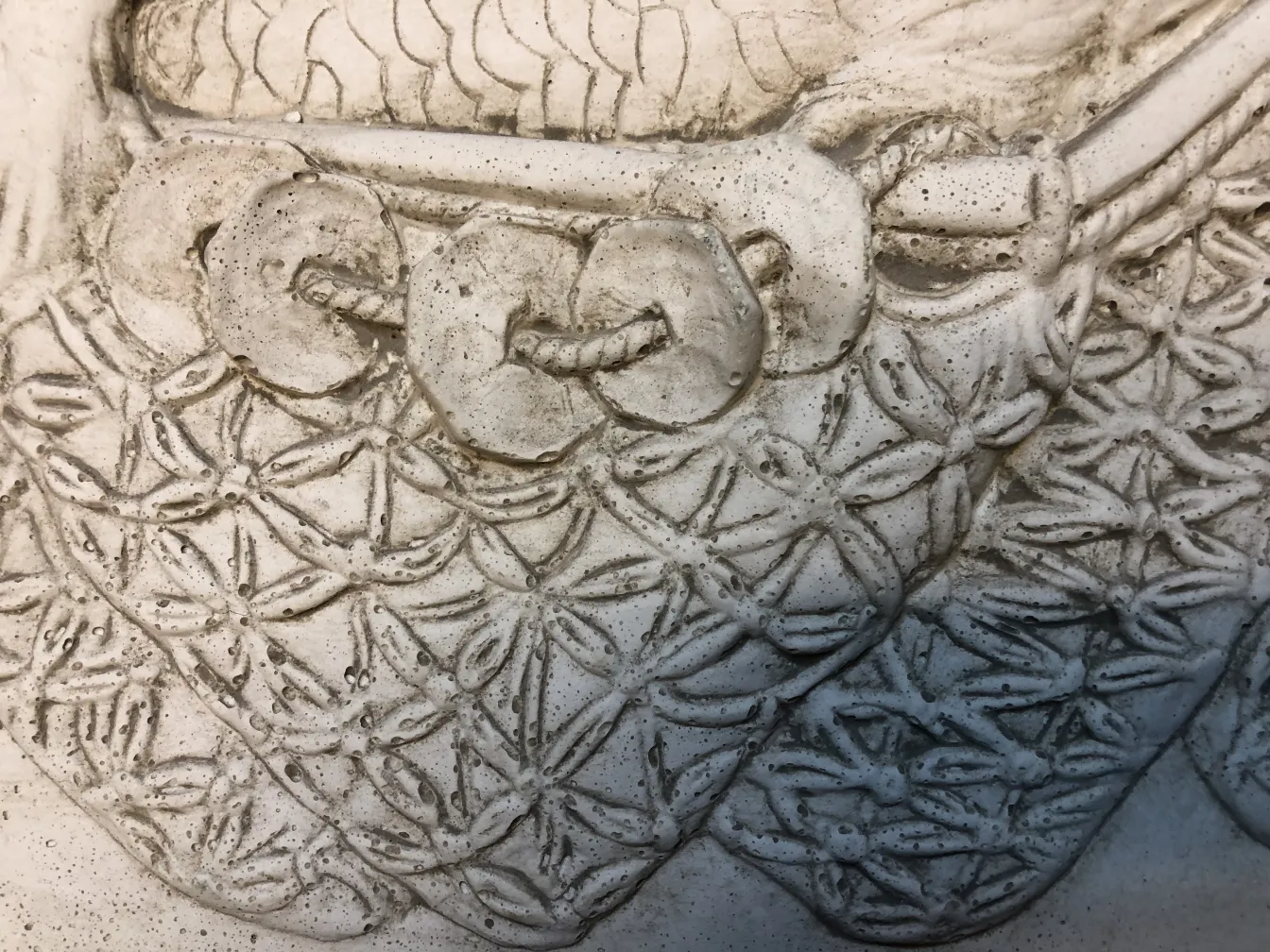 Dettaglio di una placca a muro antica con design complesso.