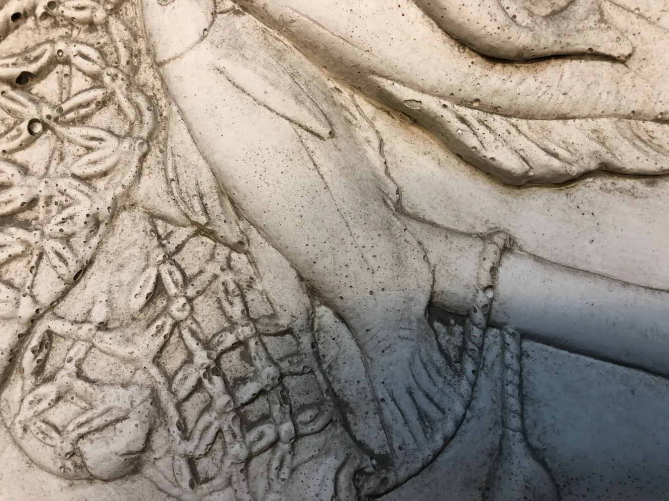 détail d'une plaque murale ancienne avec un design floral en relief