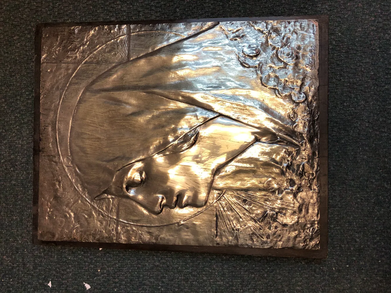 antique wall plate with relief of female figure and decorative details