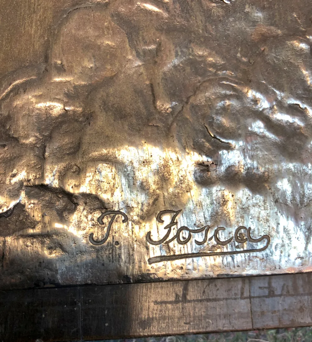 Antique wall plate with artisan design, visible engravings.