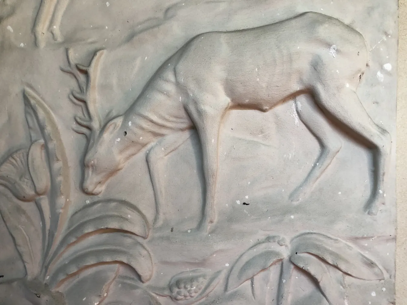 Antique wall plate featuring a deer and foliage design.