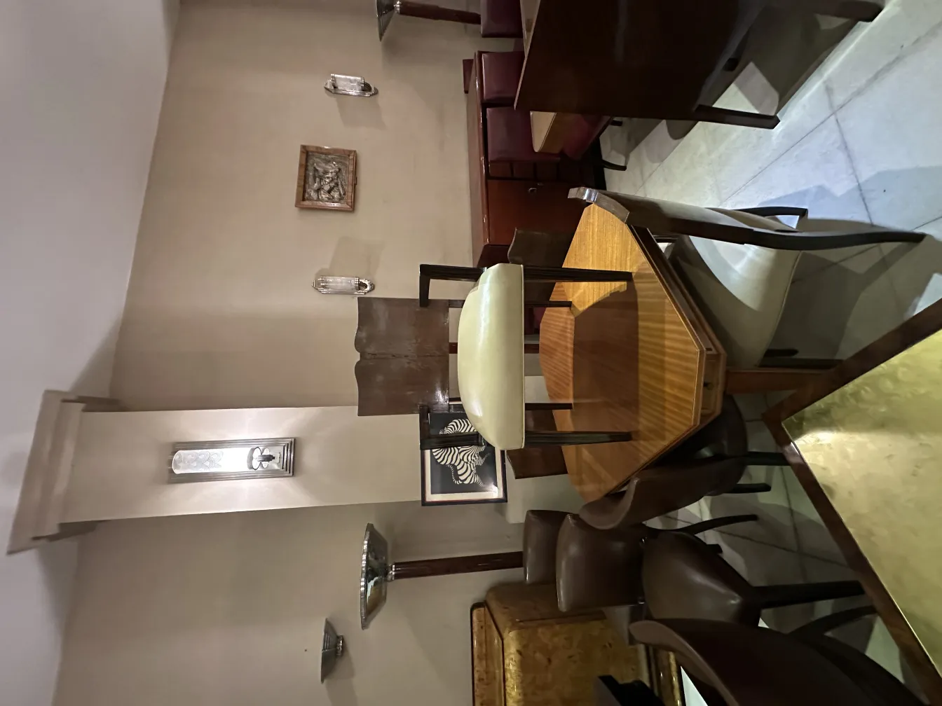 View of an antique wall plate in a restaurant with chairs and tables.