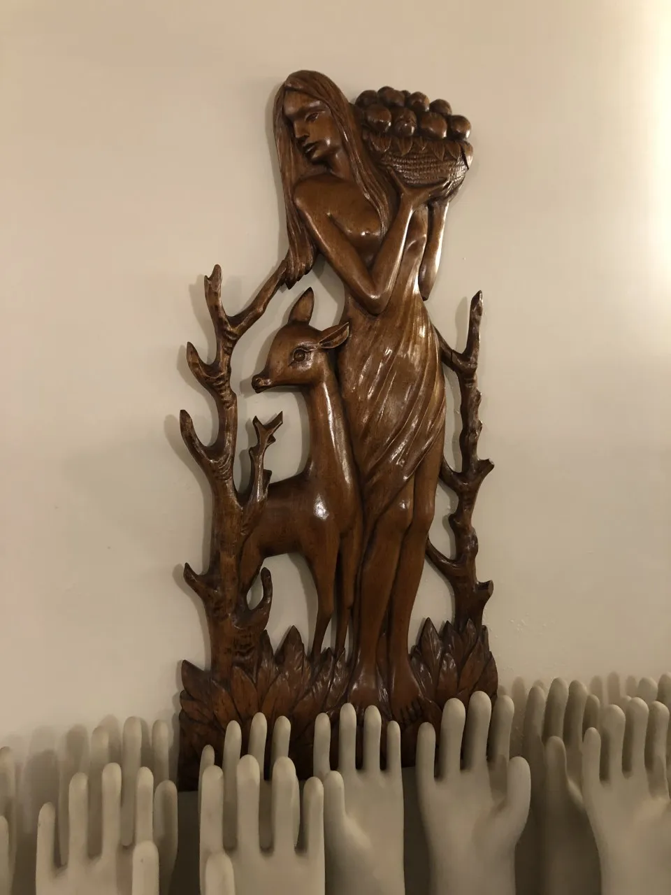 Antique wall plate featuring a woman and a deer.