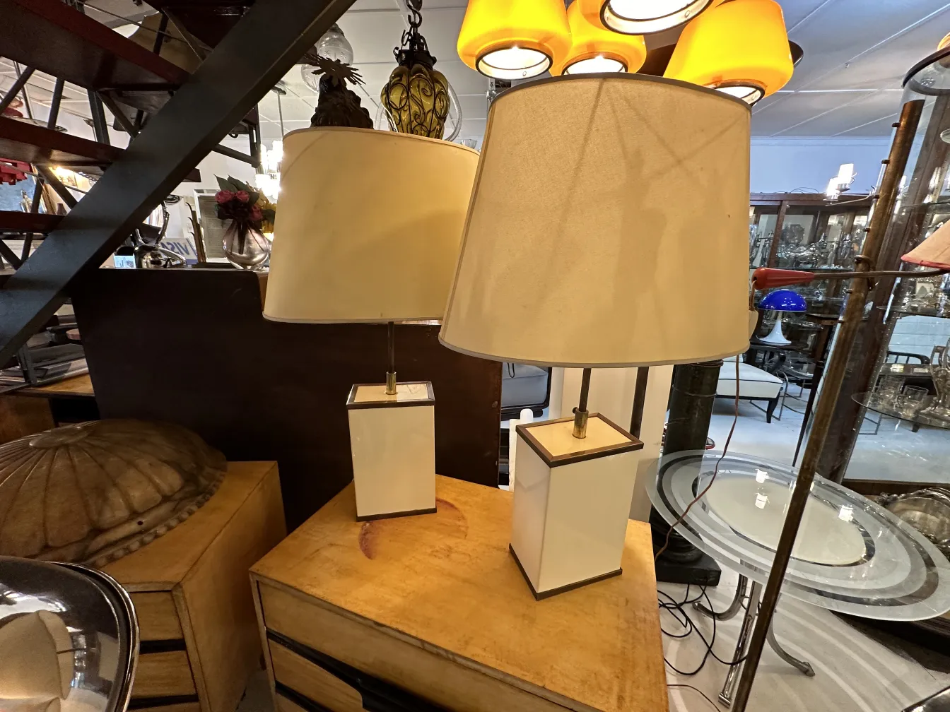 View of two antique table lamps with clear shades in a decorative environment