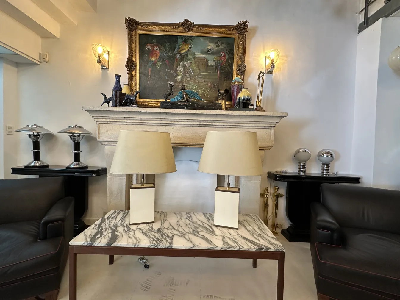 2 antique table lamps on a marble table in an elegant setting.