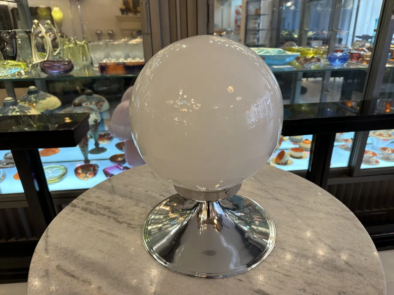 Par de lámparas de mesa antiguas con base brillante, en un entorno elegante de antigüedades