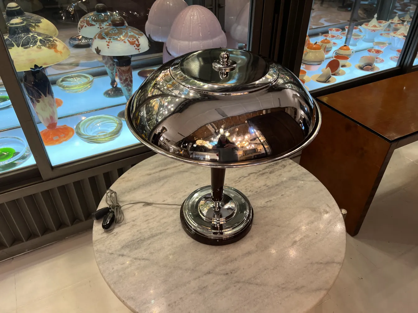 Two antique table lamps with shine on a marble table.