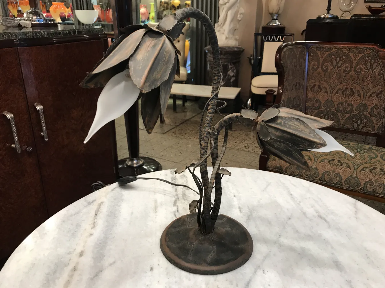 two decorative antique table lamps on a marble table