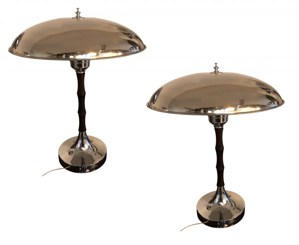 Two antique table lamps with shiny bases and round shades.