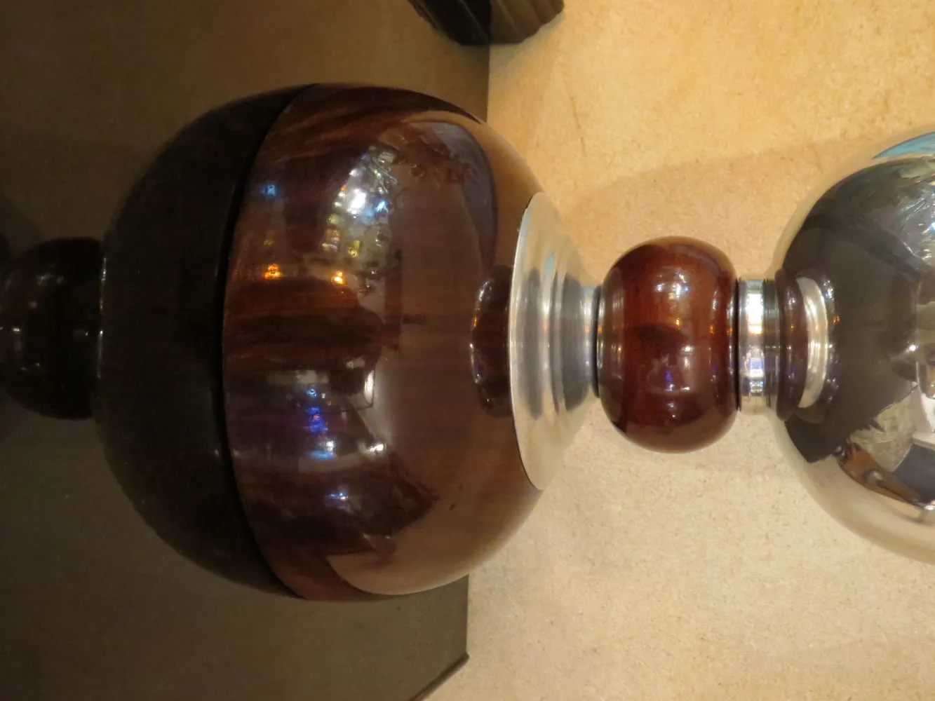 Details of two antique decorative table lamps with distinctive bases and lights.