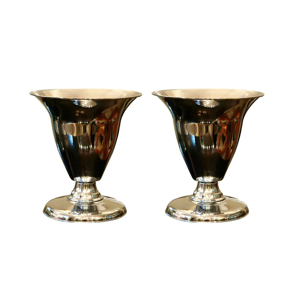 Two shiny antique table lamps with elegant stylized bases.