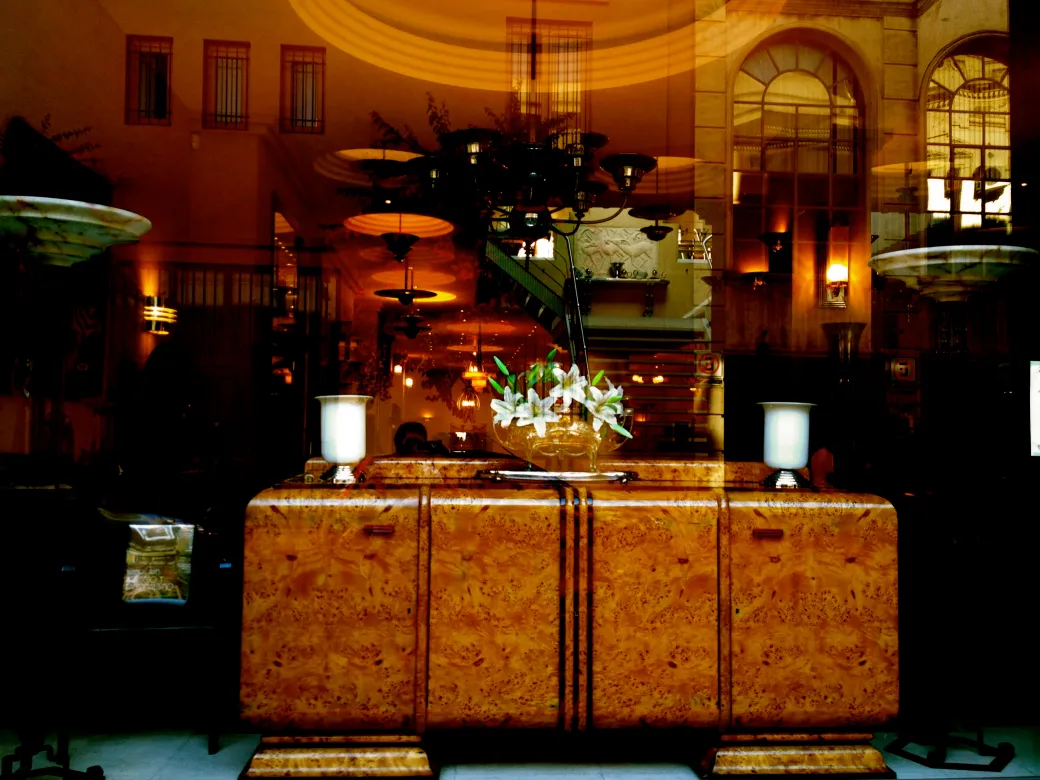 Showcase with 2 antique table lamps on an elegant chest