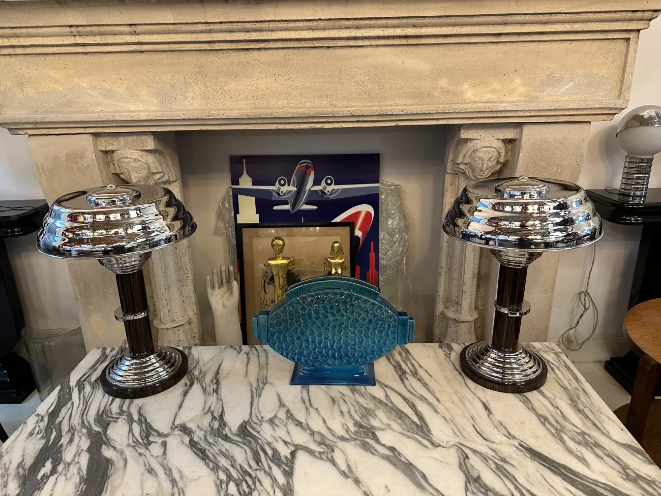 Duas lâmpadas de mesa antigas com design elegante sobre uma mesa de mármore.