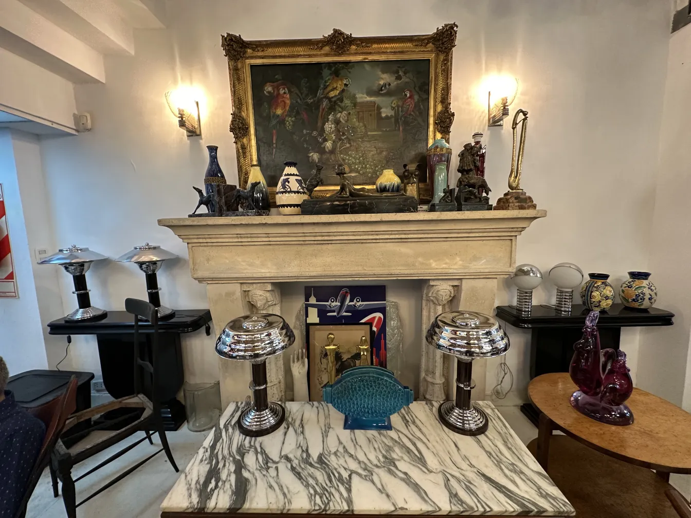 2 antique table lamps on a marble table, with shiny bases and a visually rich environment.