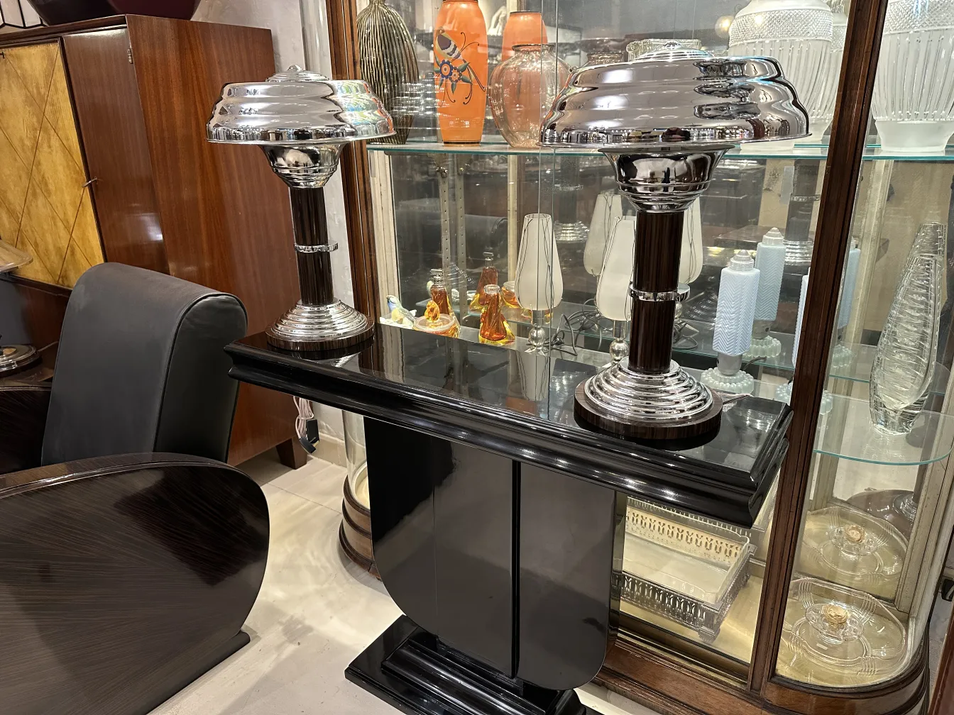 two shiny vintage table lamps on a black table, elegant setting