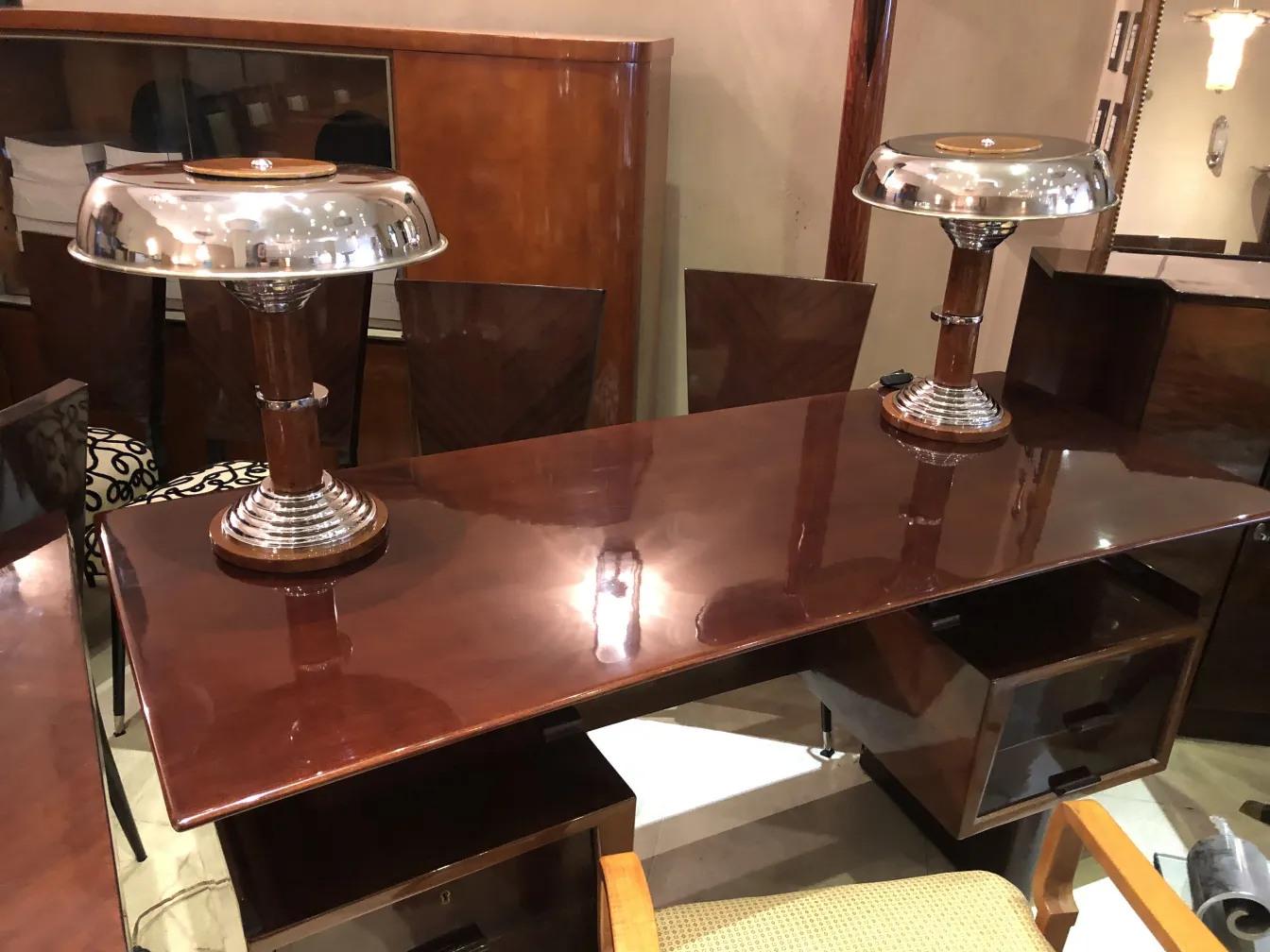 Front view of 2 antique table lamps with chrome finish on a table