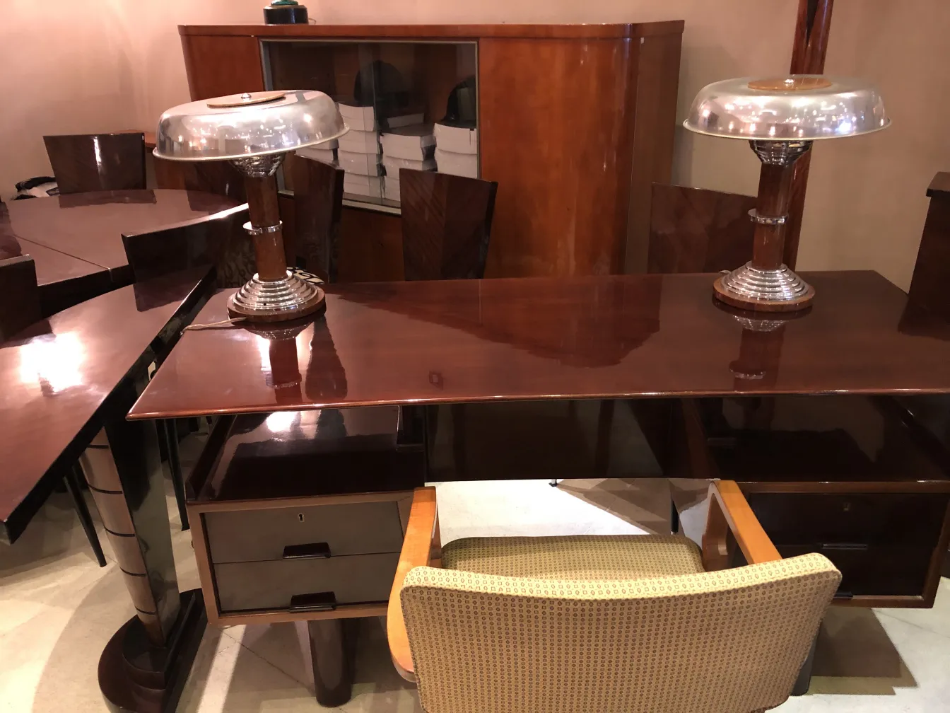 two antique table lamps with shiny bases and metallic shades on a desk