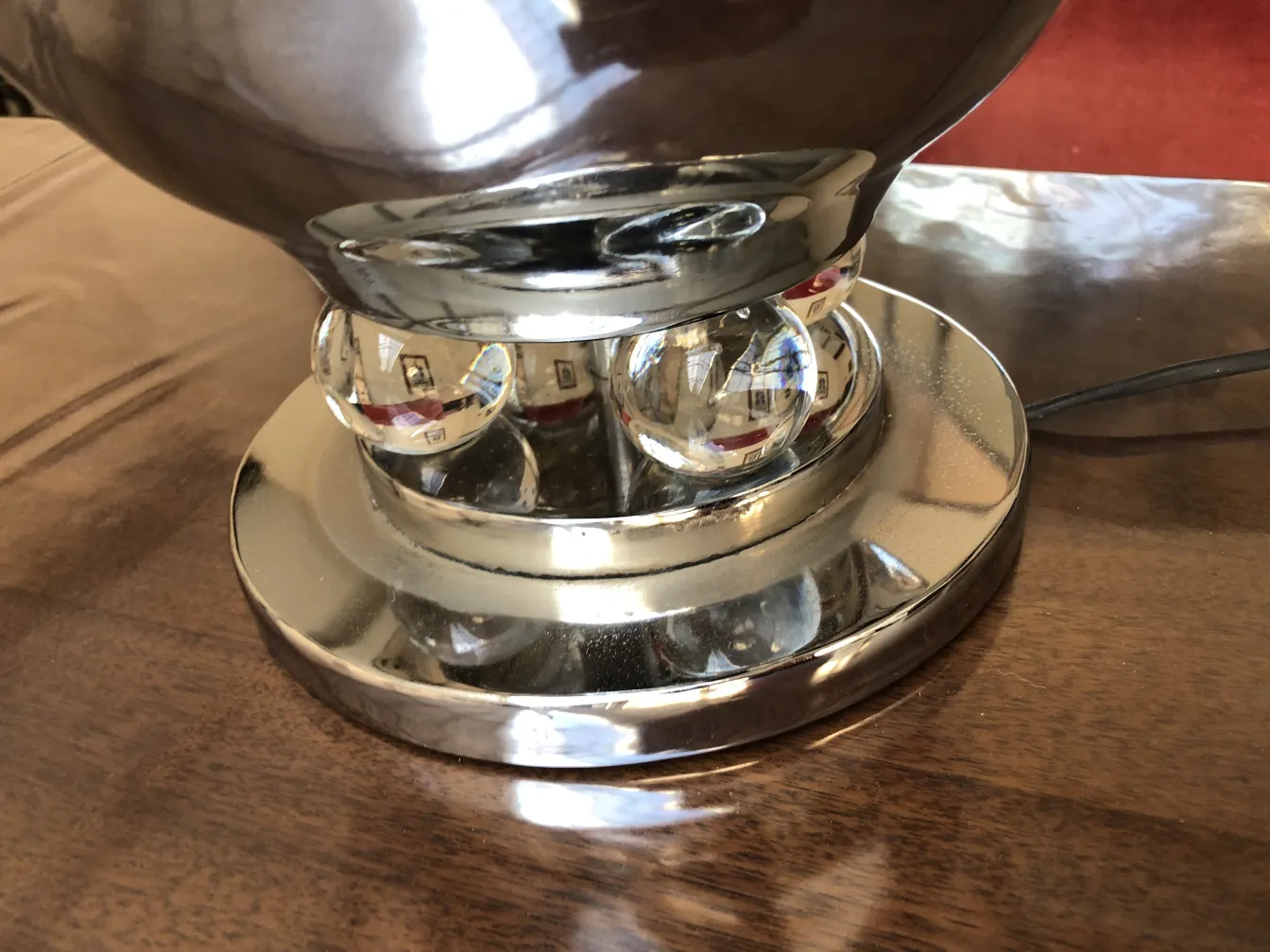 Detalhe de antigas lampadas de mesa decorativas com base redonda e esfera reflexiva.