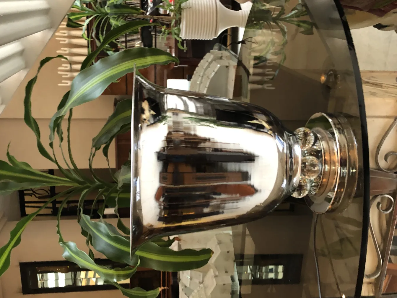 A pair of antique table lamps with decorative base in an elegant setting.