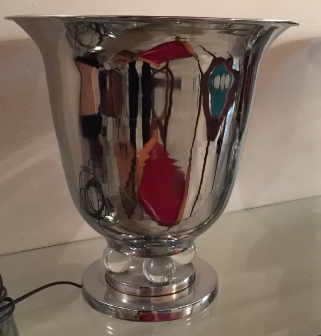 2 antique table lamps with shiny forms and vibrant colors in a lit setting