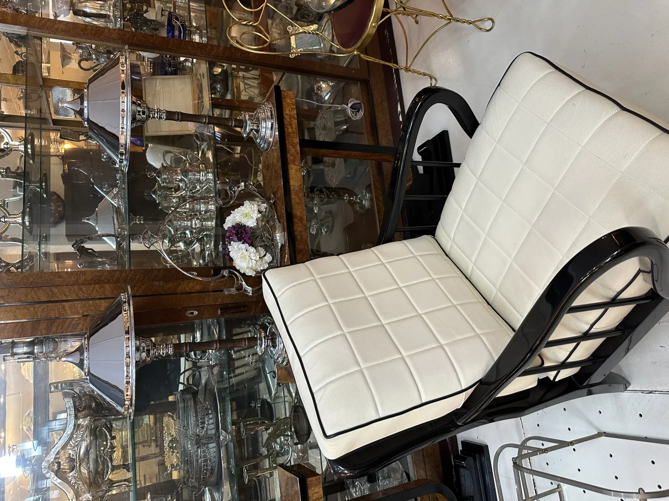 two antique table lamps with a white chair in the background