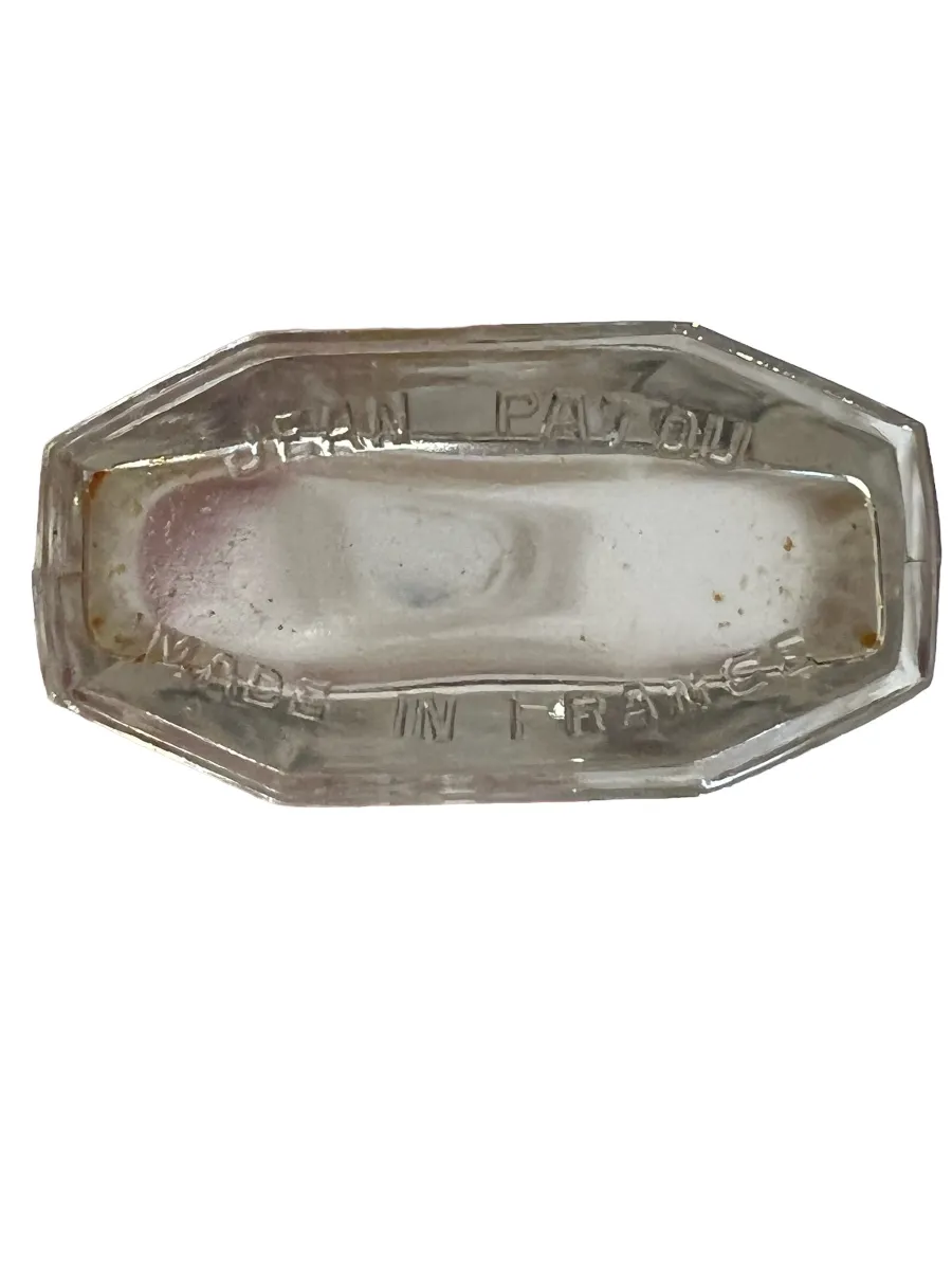 Antique perfume bottle with octagonal design and engraving.