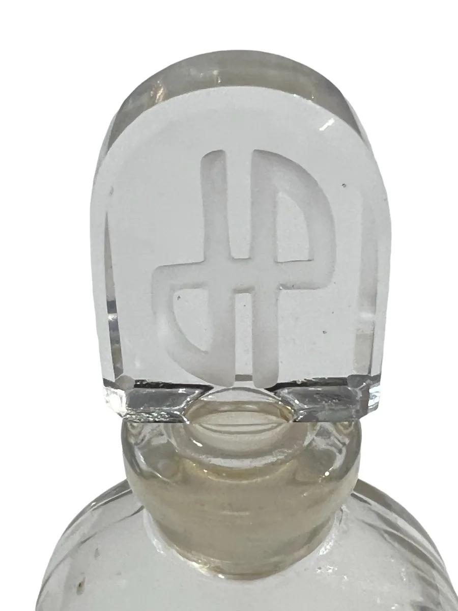 Flacon de parfum ancien avec bouchon en verre, élégant et nostalgique.