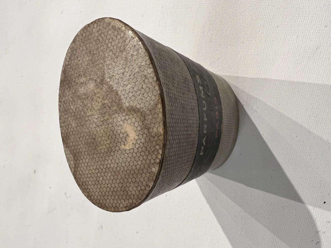 Antique perfume bottle with unique details and rounded shape in a simple environment.