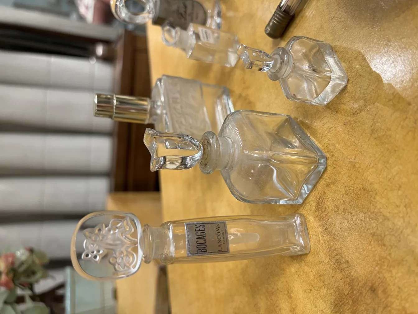 Antique perfume bottle with decorative details, in a warm setting.