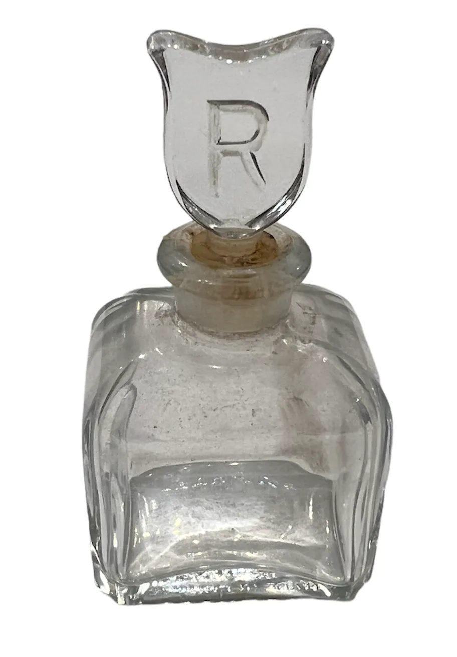 flacon de parfum antique avec couvercle décoratif en forme de bouclier