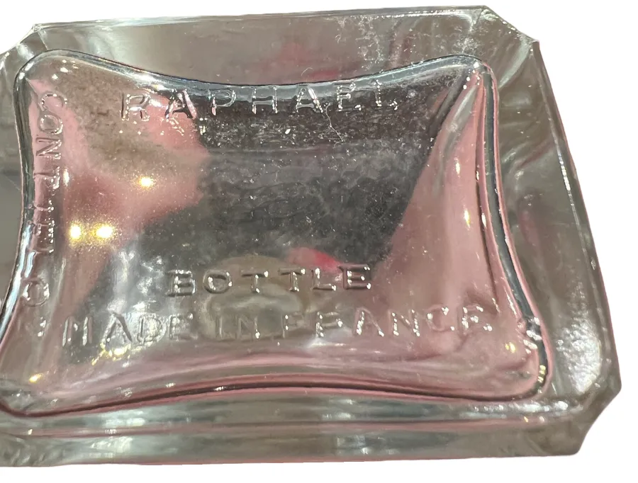 Frasco de perfume antigo de Raphael, transparente e elegantemente projetado com detalhes distintos
