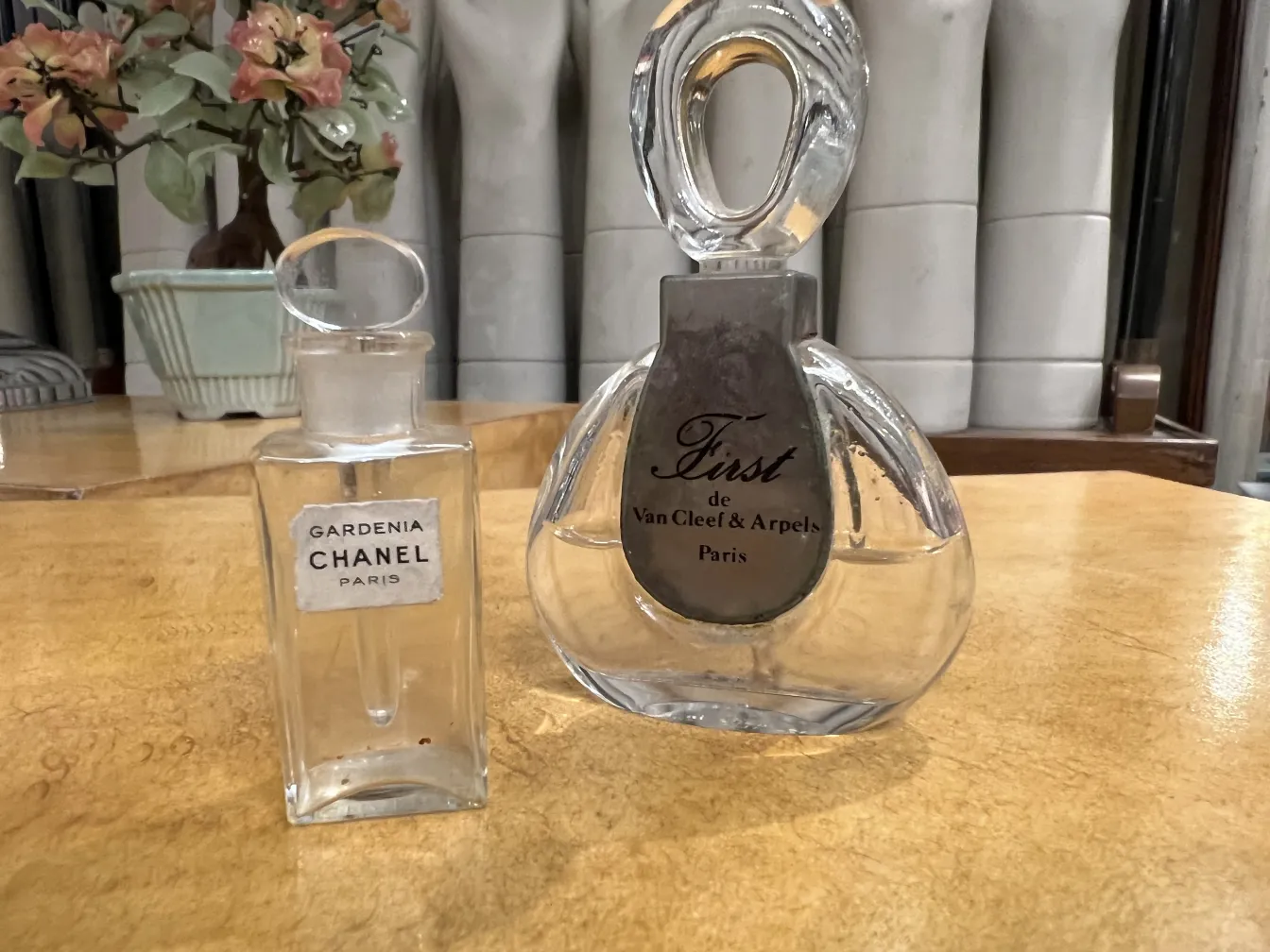 antique perfume bottle Gardenia by Chanel on wooden table